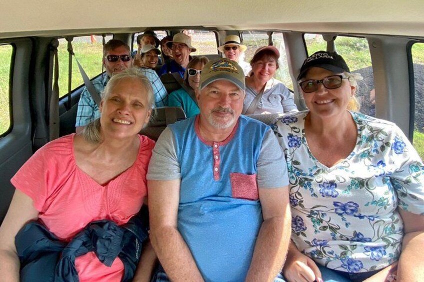 A group of people seated inside a vehicle. 2