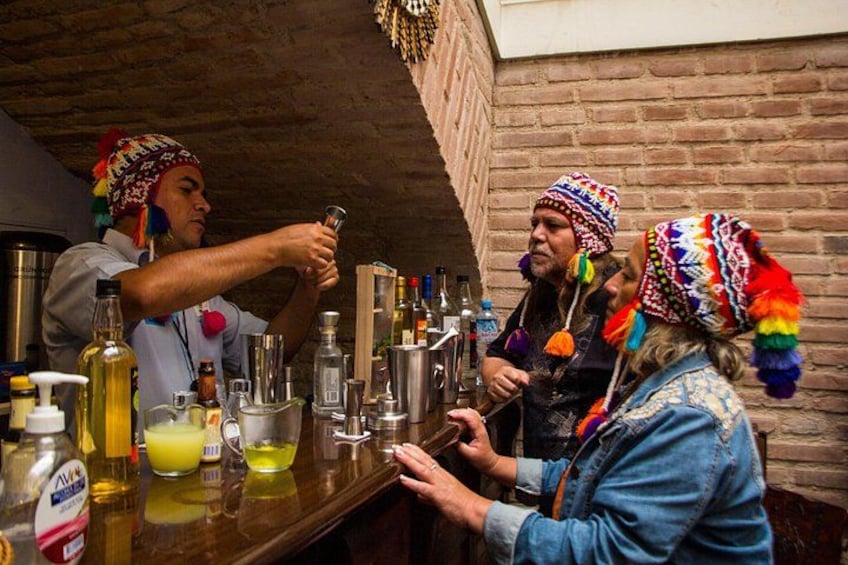 A person pouring a drink at a bar with various bottles and glasses. 3