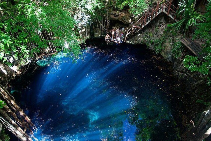 A natural pool surrounded by lush greenery. 1
