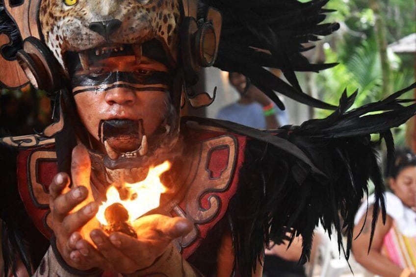 A person in a costume with a leopard headpiece, holding a torch. 2