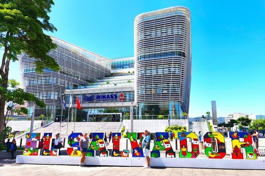 A modern building with a curved facade and a glass entrance. 4
