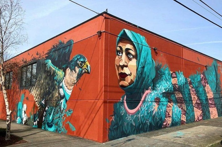 A building with a mural of a bird and a person. 2