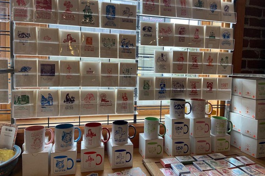 A display of mugs and boxes with various designs and text. 4