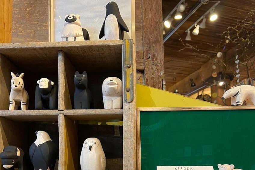 Wooden animal figurines on shelves, a chalkboard, and a wooden structure. 2