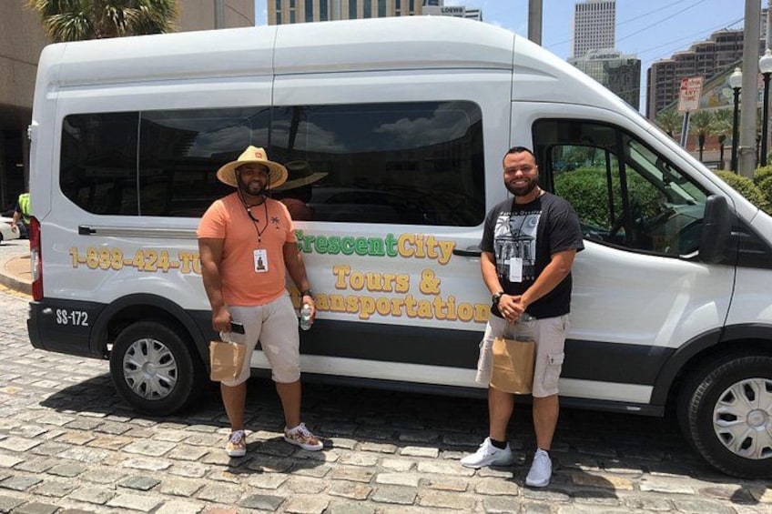Two men standing in front of a white van with 'Crescent City Tours & Transportation' written on it. 3
