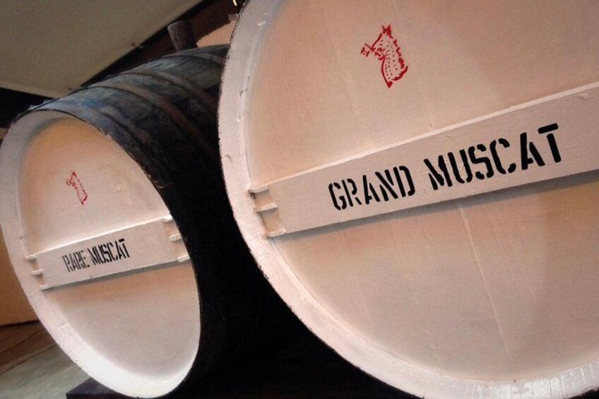 Två stora, cylindriska föremål märkta med texten ”Grand Muscat”. 2