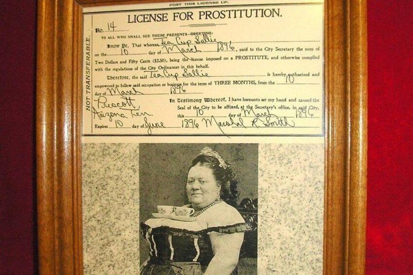 A historical license for prostitution document from 1872, featuring a photograph of a woman in period attire. 3