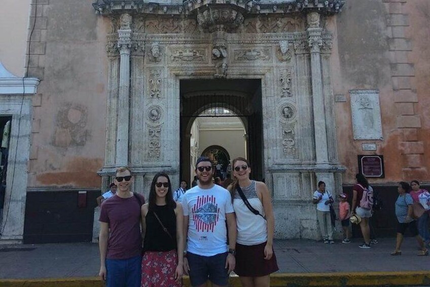 A group of people standing in front of a historic building with ornate architecture. 5