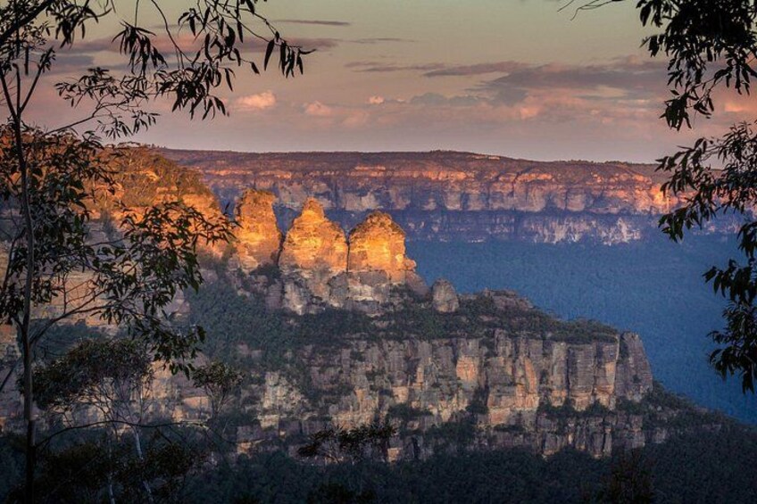 A canyon with prominent rock formations and a sunset sky. 1