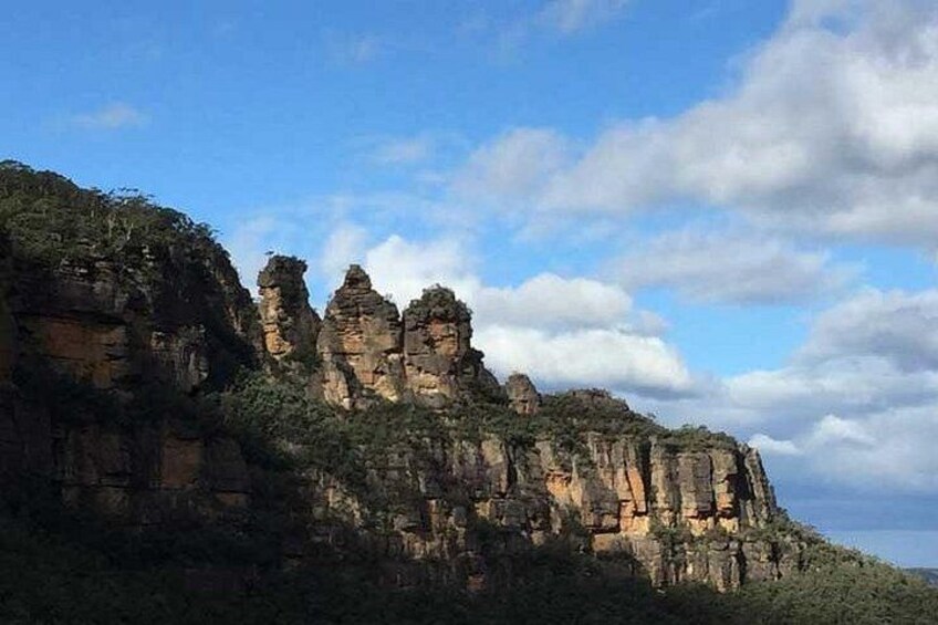 A rugged cliff with distinct rock formations and sparse vegetation. 4