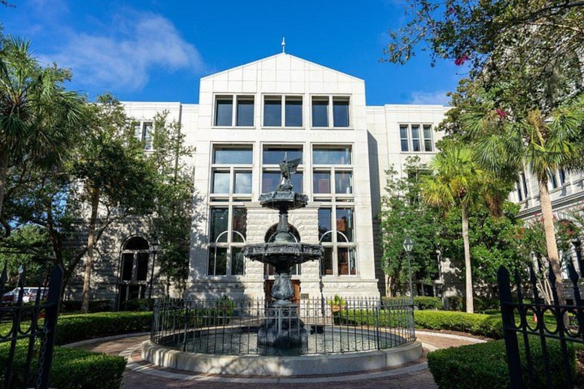 A building with a fountain in front. 2
