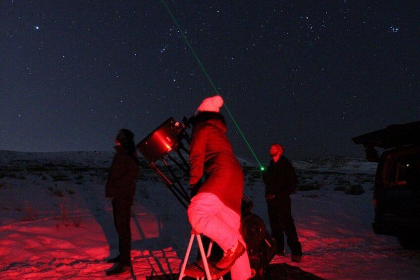 A group of people observing the night sky with telescopes. 5