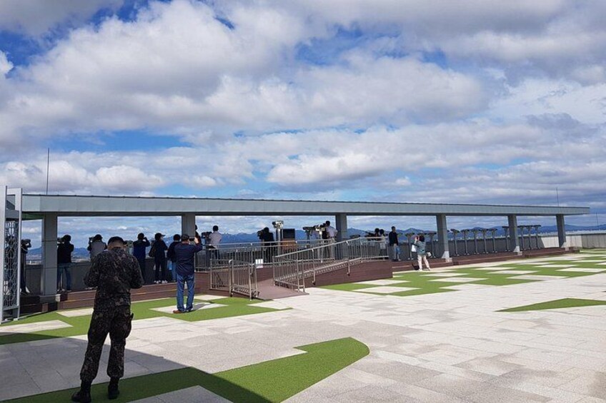 A viewing platform with people observing the landscape. 3