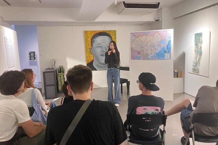 An art gallery with a large portrait and a map on the walls. 2