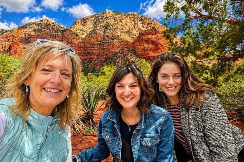 Three people in front of a rocky mountain landscape. 3