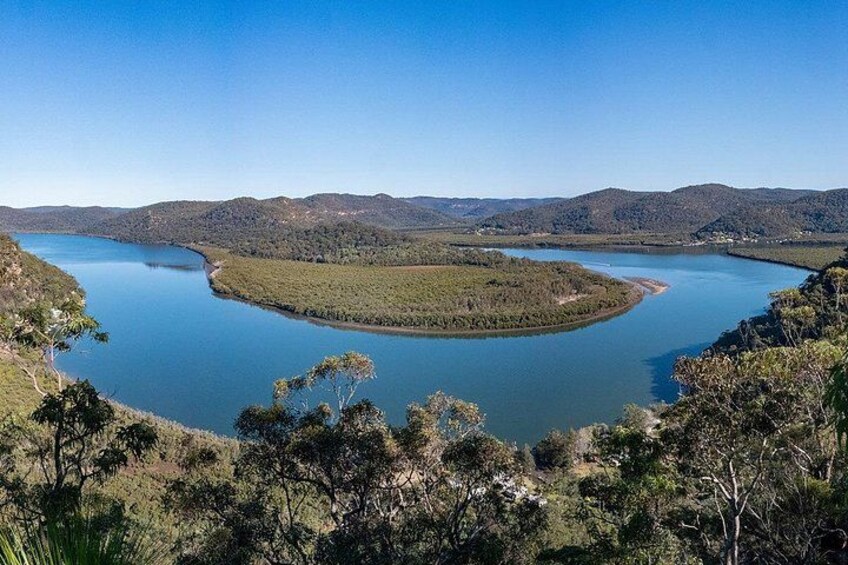 A large lake surrounded by hills and trees. 5