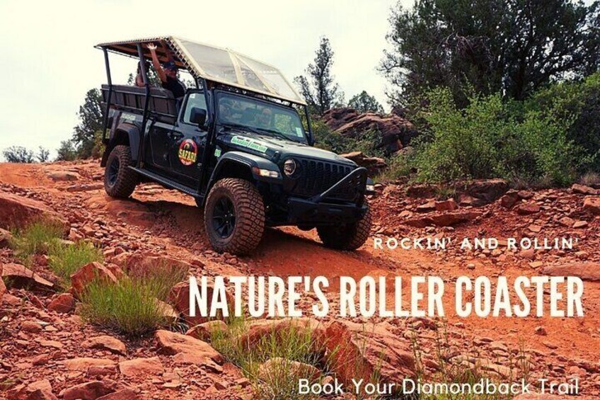A black off-road vehicle on a rocky trail with a canopy. 2