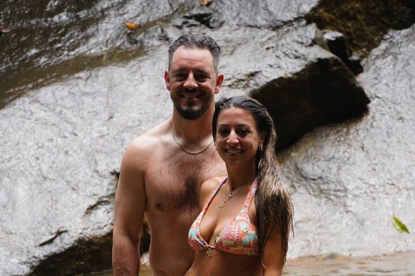 Un couple se tient devant une cascade rocheuse. 2