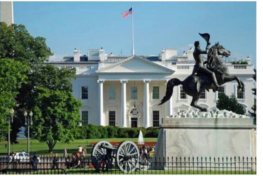 The White House with a statue of a man on a horse in front. 2
