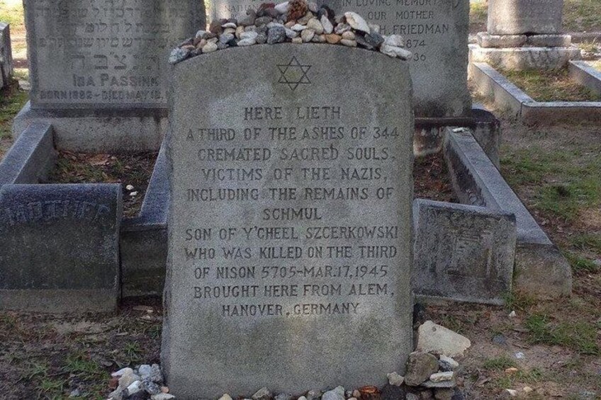 A gravestone with inscriptions in multiple languages, including Hebrew, and mentions Holocaust victims. 2