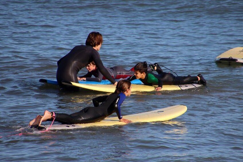 People in wetsuits on surfboards in the water. 3