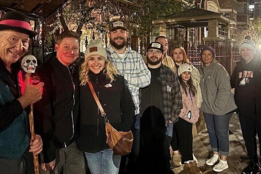 A group of people standing outdoors at night. 3