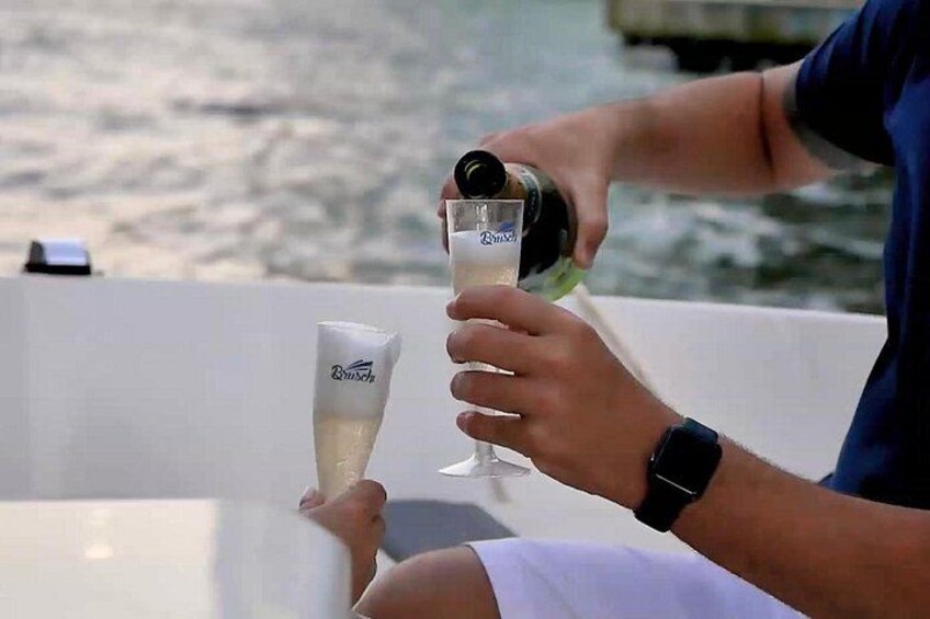 Eine Person gießt ein Getränk in ein Glas auf einem Boot. 5