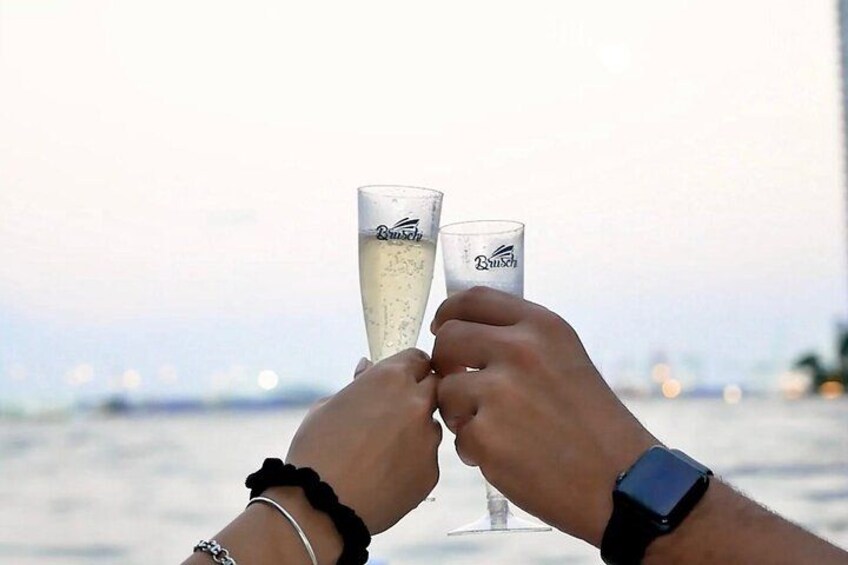 Two people toasting with champagne glasses, a smartwatch on one wrist, and a bracelet on the other. 4