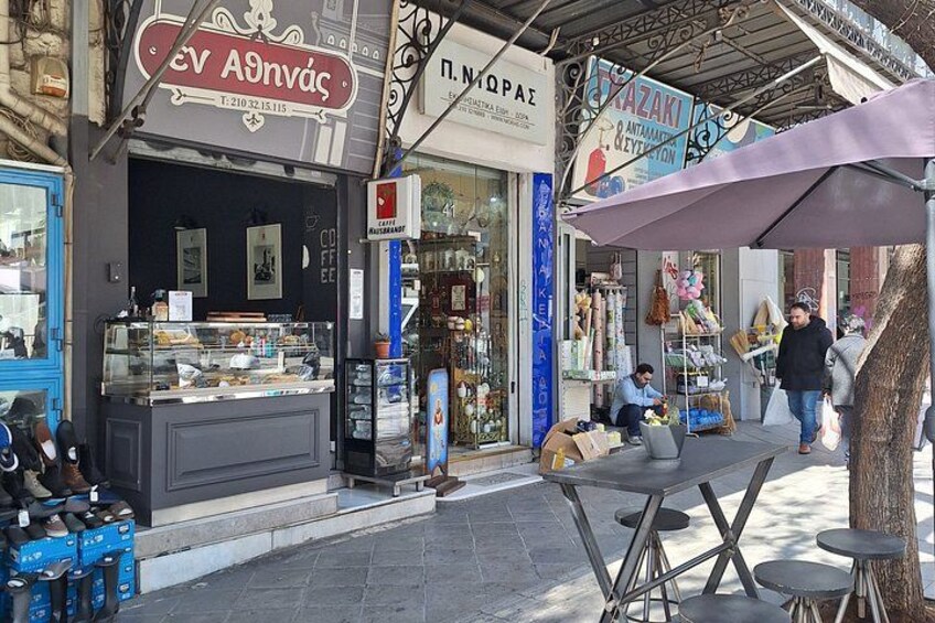 A street with shops, a café, and outdoor seating. 4