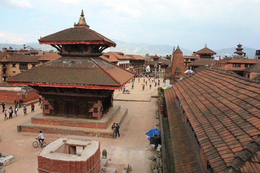 A traditional temple complex with tiered roofs and brick structures. 4