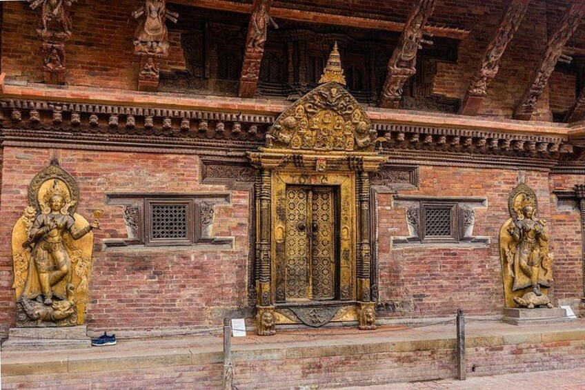 A temple with intricate carvings, a central golden shrine, and statues on either side. 3