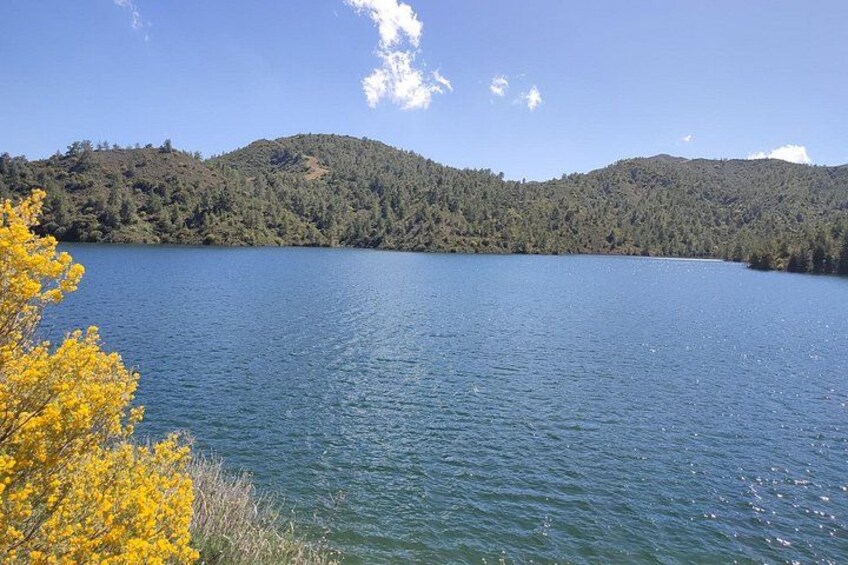 A lake surrounded by forested hills. 2