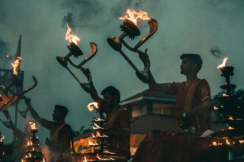 A group of people holding flaming torches, possibly during a cultural or religious event. 1