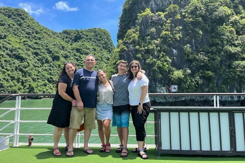 A group of people on a boat with a mountainous landscape in the background. 3