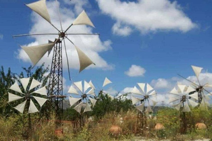 Windmills in a field with a clear sky. 1