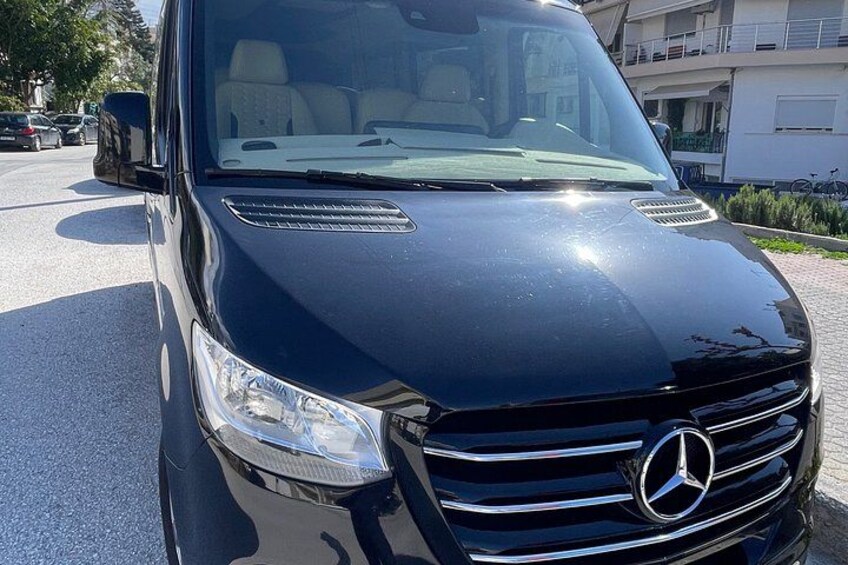 A black Mercedes-Benz van parked on a street. 2