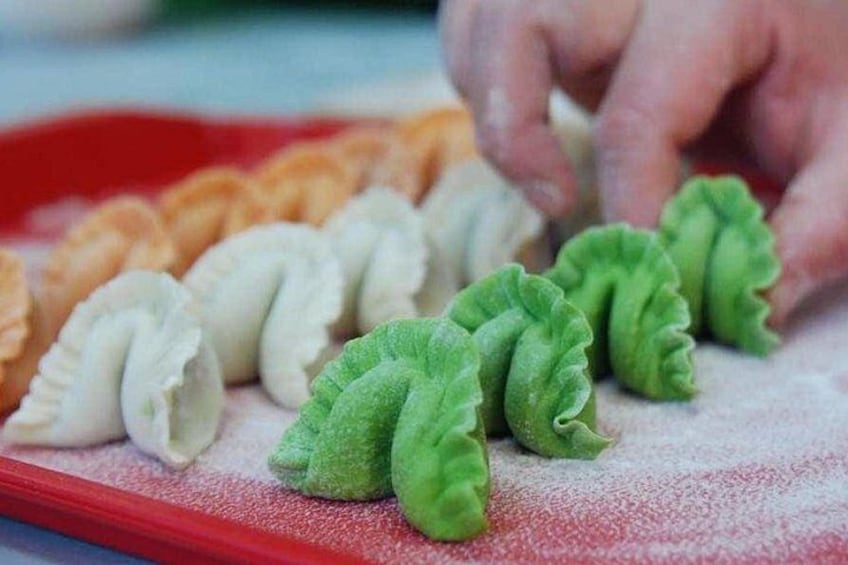A variety of dumplings on a tray. 1