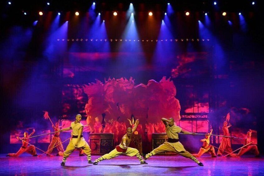 A stage with dancers in yellow costumes performing a synchronized routine. 5