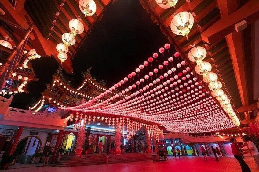 A traditional building with red lanterns and a red roof. 2