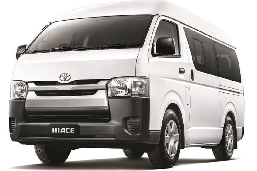 A white Hiace van with a black front grille and side windows. 3