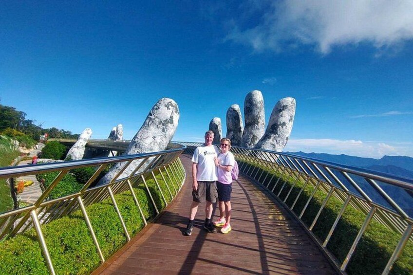A wooden boardwalk with metal railings, leading to a viewpoint with large rock formations. 1