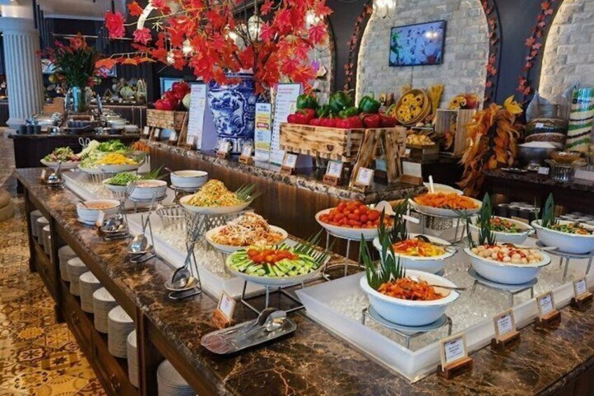 A buffet with various food items and decorative elements. 3