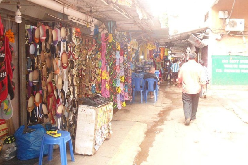 A market with various items for sale, including colorful bags and shoes. 5