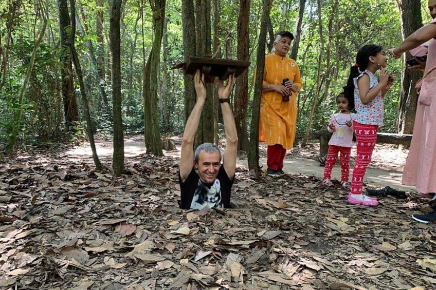A forest with people, some holding objects above their heads. 4