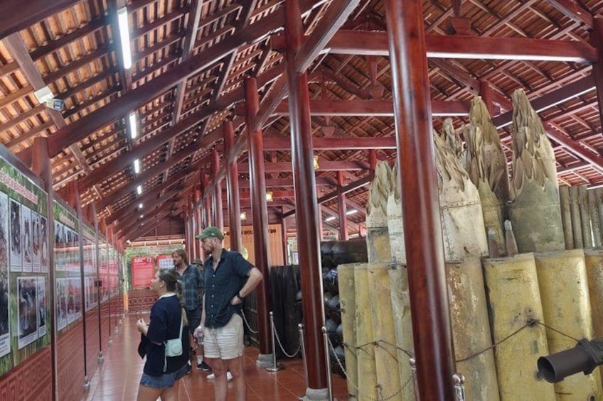 An indoor exhibit with wooden beams, informational posters, and large sculptures. 4