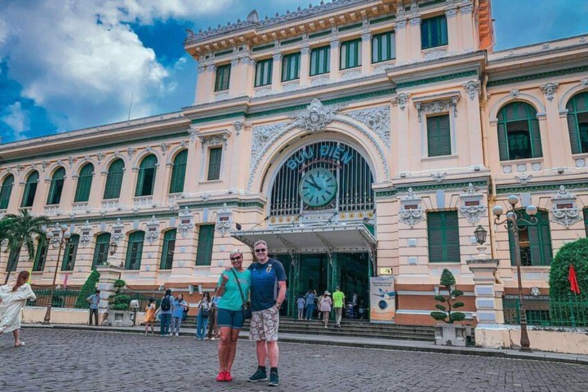 A historic building with ornate architecture, a prominent clock, and a cobblestone street. 1