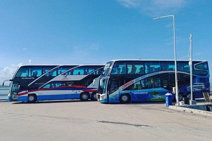 Two double-decker buses parked at a bus station. 4