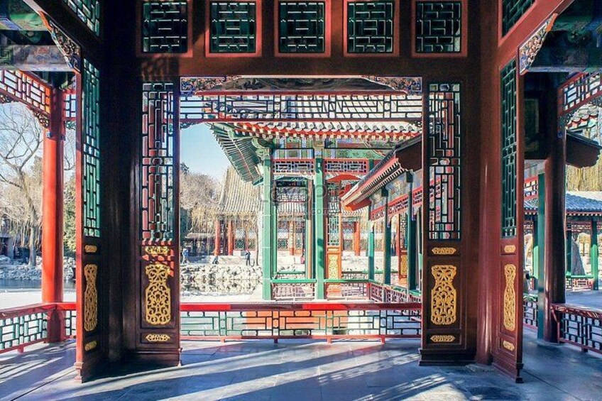 A traditional Chinese pavilion with intricate lattice work and red pillars. 4