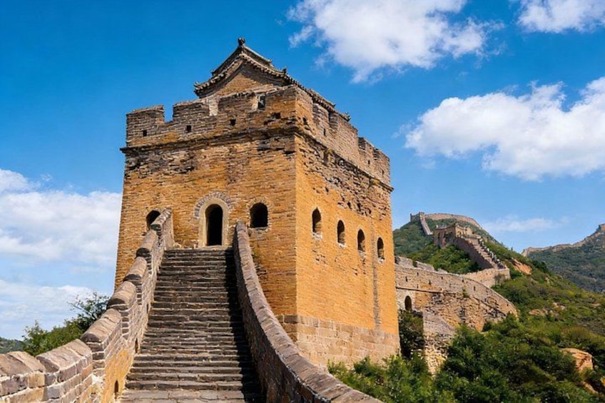 The Great Wall of China with a tower and a staircase leading up to it. 2
