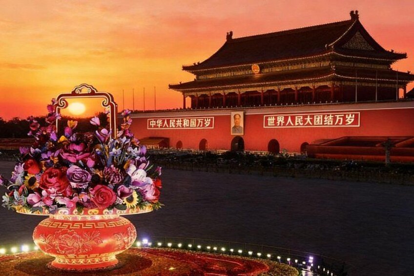 A traditional Chinese building with a red wall and golden roof, illuminated by sunset. 1